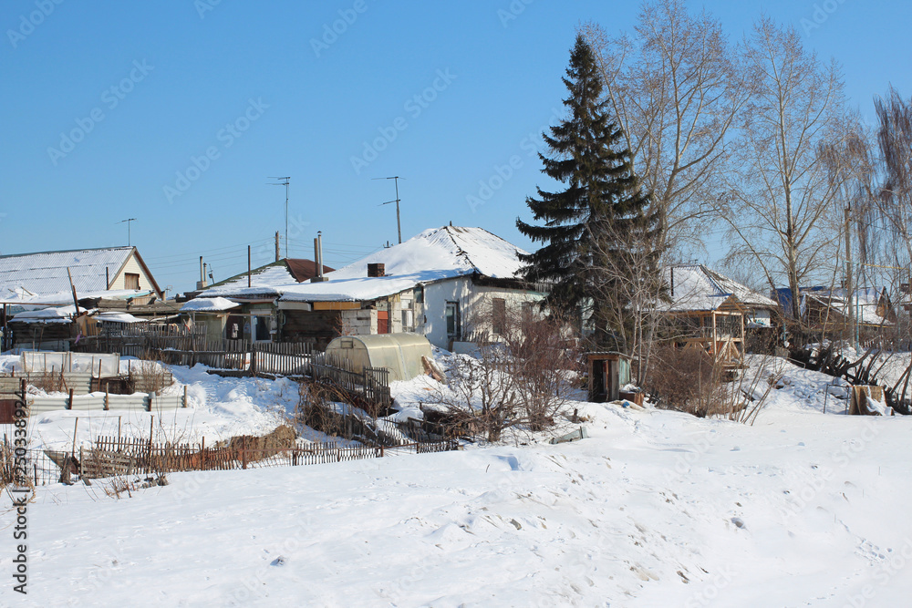 view of the holiday village evergreen coniferous tree spruce near a wooden house in the winter