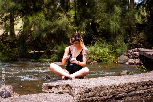 woman sitting on rock in forest