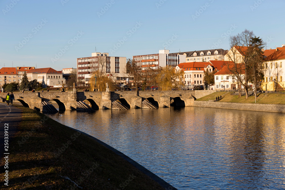 Obraz premium Sunny winter oldest stone bridge in central Europe above River Otava, Pisek, Czech Republic