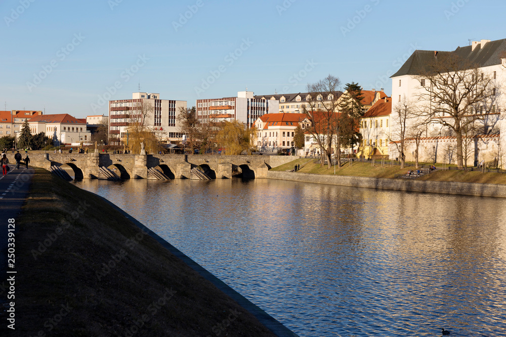 Sunny winter oldest stone bridge in central Europe above River Otava, Pisek, Czech Republic