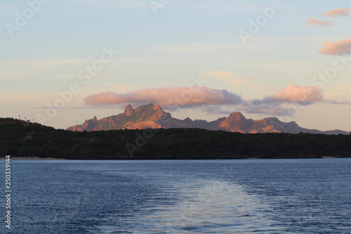 View at dawn of some islands of the Yasawa with the mountains of the Waya island in the background, Fiji