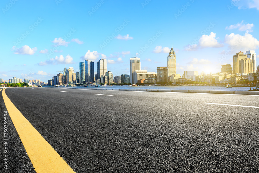 Empty asphalt road through the Shanghai Bund business district Empty asphalt road through the Shanghai Bund business district