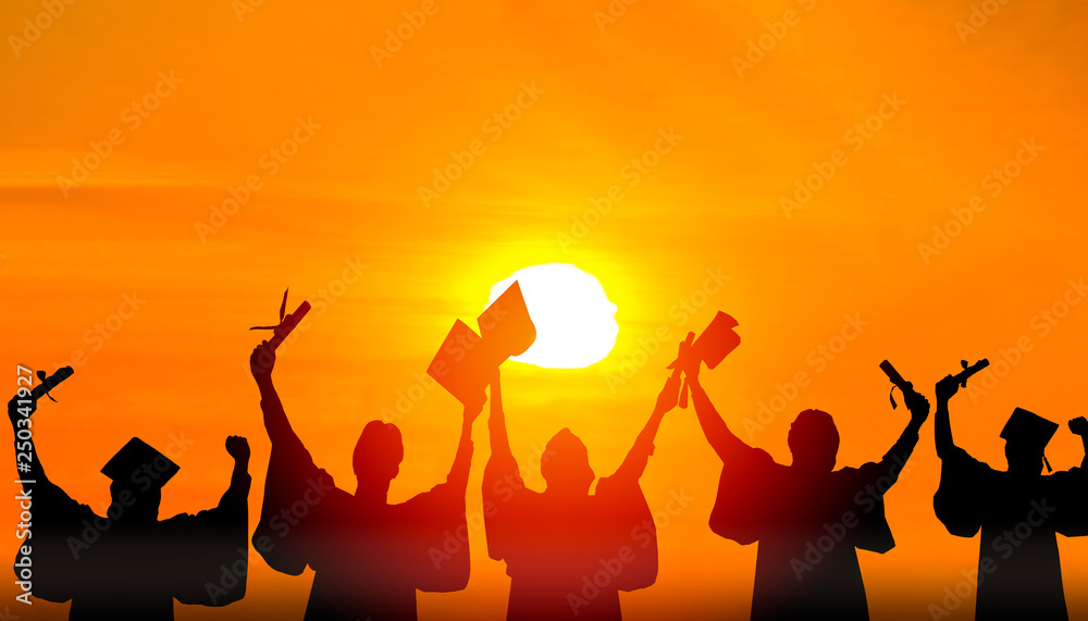 Silhouette of Student Graduation. They are seeing sunset. They are standing and show hand.They are celebration in Graduate , Education,academic, Photo concept Silhouette and Success