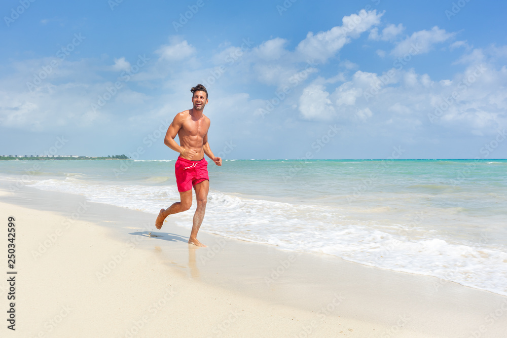 Young man running  at the  beach