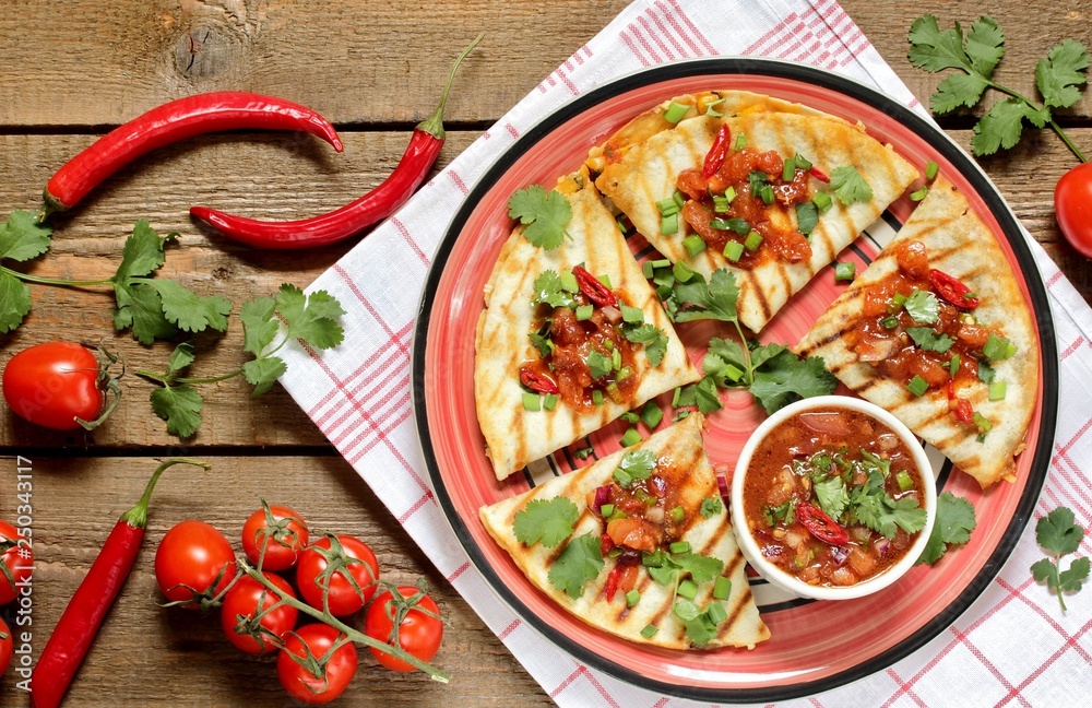 Quesadilla grill with spicy salsa with chili pepper. Mexican traditional food, wheat tortillas. top view. 