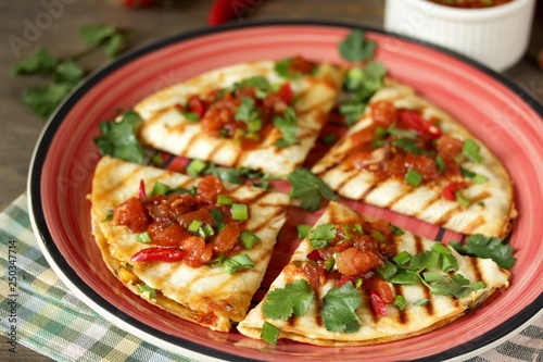Quesadilla grill with spicy salsa with chili pepper. Mexican traditional food, wheat tortillas. 