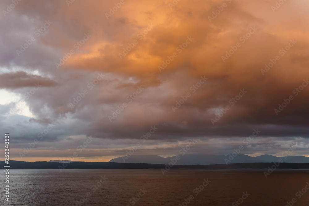 orange sunset in Strait of Georgia near Vancouver Island British Columbia Canada.