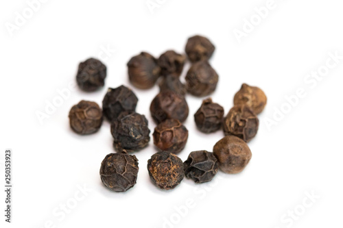 image of black pepper seeds on white background. Food.
