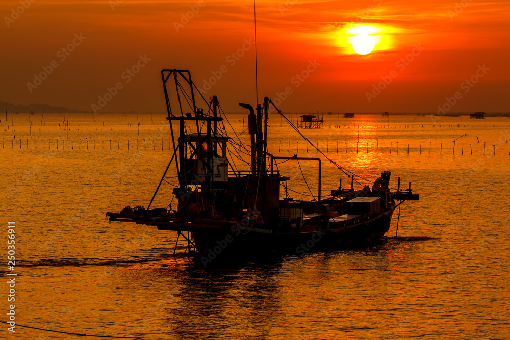 Sun reflects the sea with fishing boats