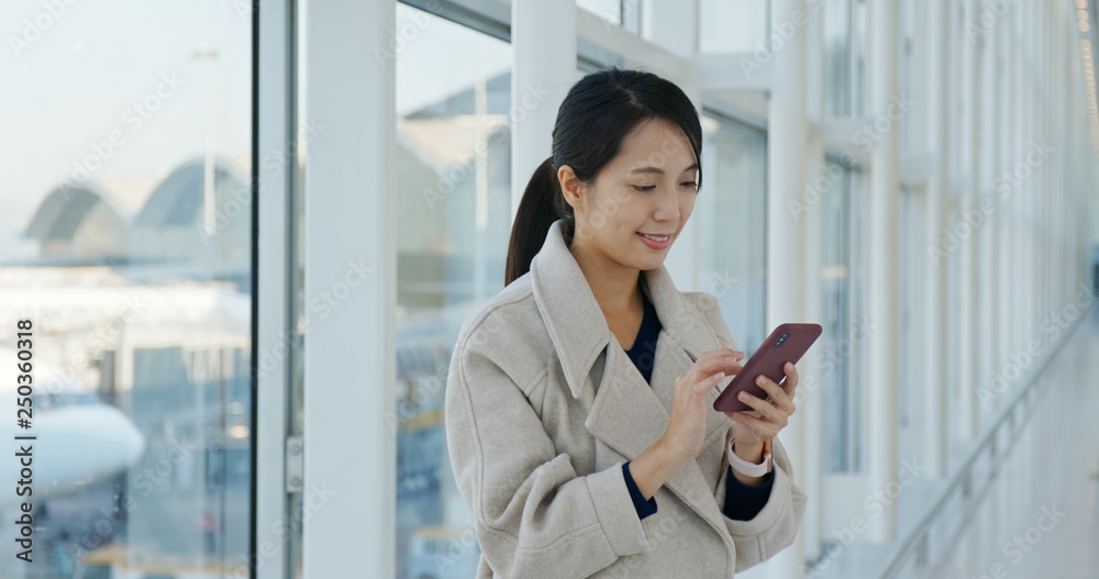 Woman use of mobile phone in the airport Woman use of mobile phone in the airport