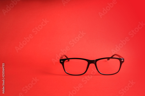 Glasses on red background