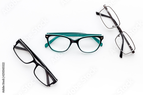 Set of glasses with transparent lenses on white background top view space for text