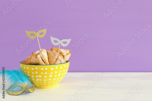 Purim celebration concept (jewish carnival holiday) over wooden table