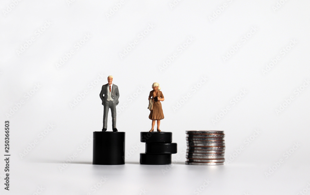 Equal labor equal pay concept. Miniature woman with a miniature man. #PayMeToo as social new movement. Equal labor equal pay concept. Miniature woman with a miniature man. #PayMeToo as social new movement.