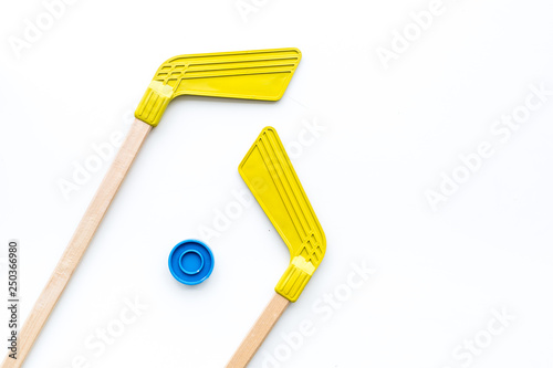 Ice hockey stick and puck on white background top view copy space photo