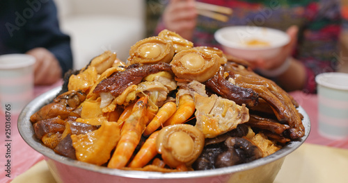 Traditional Chinese family eating big bowl feast together at home photo