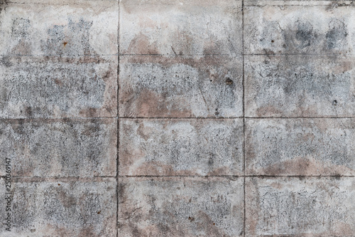 The old gray concrete block wall for background and texture which got some rusty color. The rectangle pattern.