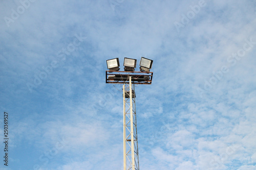 Pillar spotlights football field in the background sky cloud