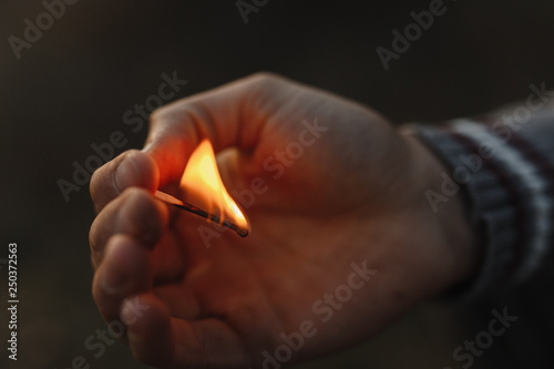 Burning match in the man hand