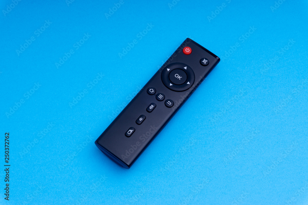Remote control TV or radio isolated on blue background with selective focus and crop fragment Remote control TV or radio isolated on blue background with selective focus and crop fragment