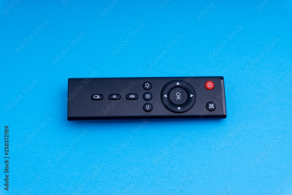 Remote control TV or radio isolated on blue background with selective focus and crop fragment Remote control TV or radio isolated on blue background with selective focus and crop fragment