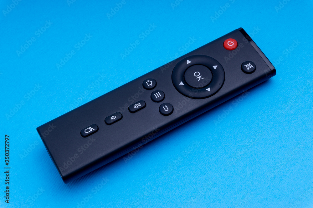 Remote control TV or radio isolated on blue background with selective focus and crop fragment Remote control TV or radio isolated on blue background with selective focus and crop fragment