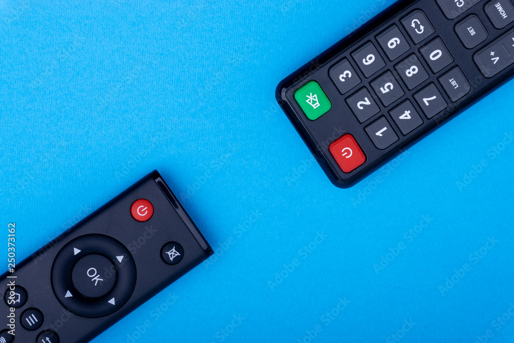 Remote control TV or radio isolated on blue background with selective focus and crop fragment Remote control TV or radio isolated on blue background with selective focus and crop fragment