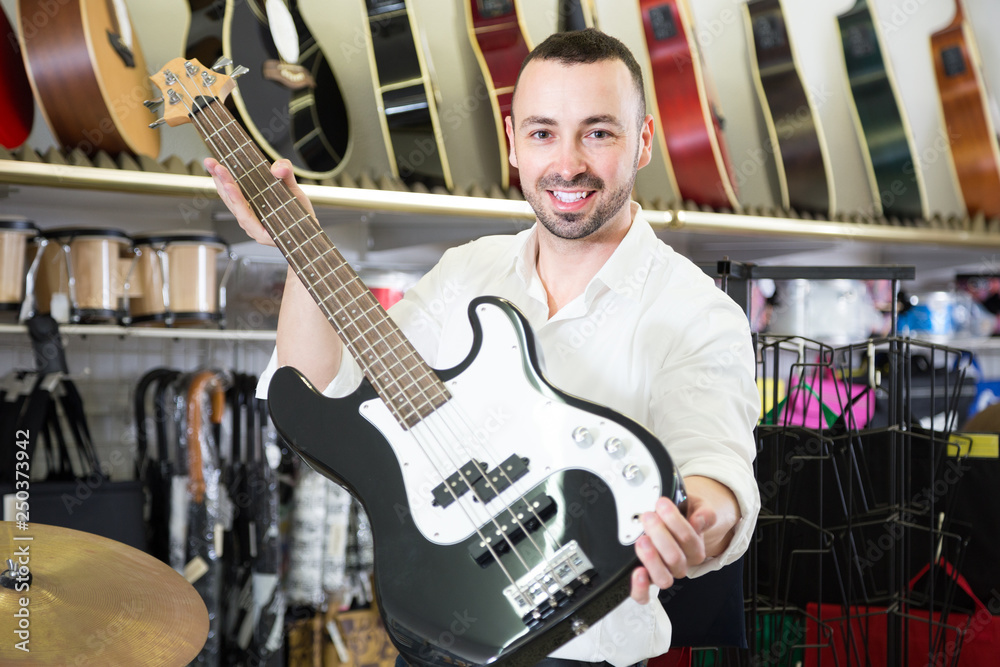Fototapeta premium male buying new guitar