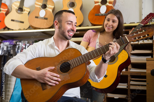 couple choosing acoustic guitar