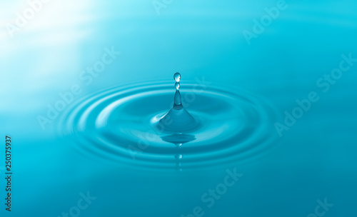 Close-up blue water drops isolated on white background.