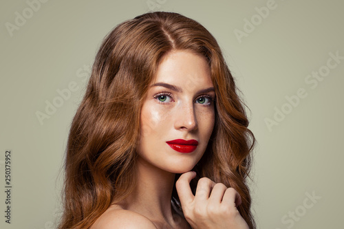 Ginger woman portrait. Attractive redhead girl with freckles and green eyes