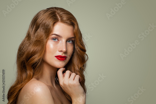 Portrait of beautiful redhead girl posing. Red haired woman with natural healthy skin with freckles