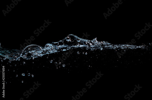 water waves splash and bubbles isolated on black background