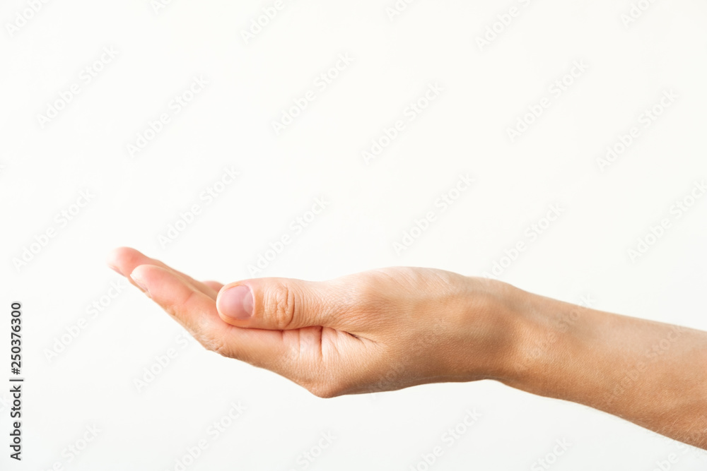Female hand on a white background. Gesture of offer or request. Female hand on a white background. Gesture of offer or request.