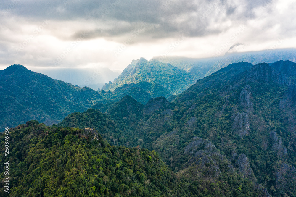 (View from above) Stunning aerial view of a beautiful little hut on top of the Pha Ngeum Viewpoint reachable by climbing a limestone mountain. Vang Vieng, Laos.