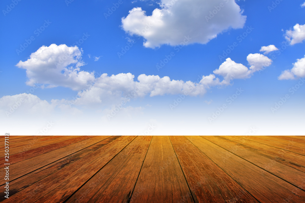 Wood table background montage White could on blue sky