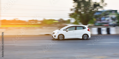 Car driving on road and Small passenger car seat on the road used for daily trips © Suriyo
