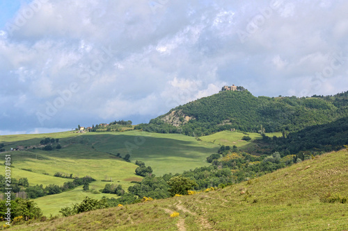 Panorama of the central Italy green hills under cloudy sky.