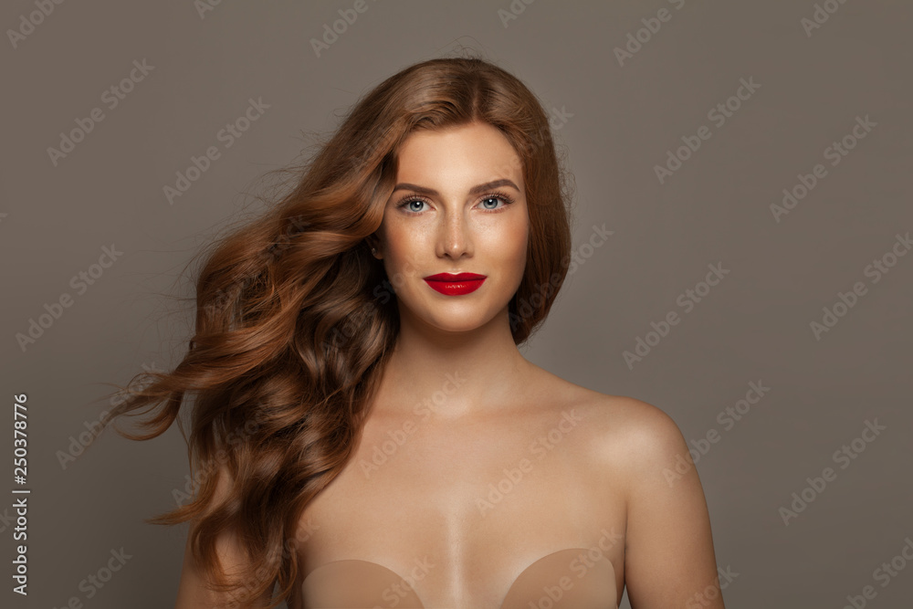 Beautiful red haired woman. Elegant redhead girl with curly hair and elegant makeup Beautiful red haired woman. Elegant redhead girl with curly hair and elegant makeup