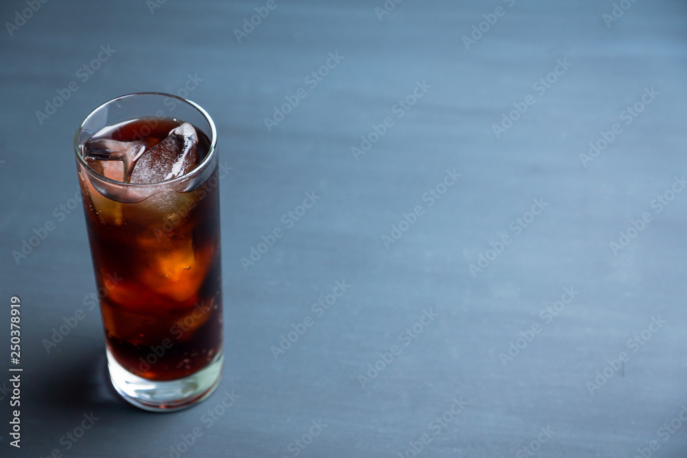 Cold cola beverage in glass with ice. Selective focus. Shallow depth of field. Cold cola beverage in glass with ice. Selective focus. Shallow depth of field.