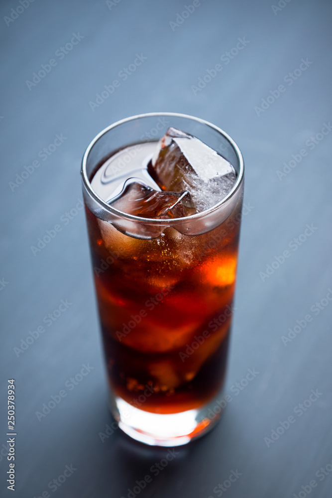 Cold cola beverage in glass with ice. Selective focus. Shallow depth of field. Cold cola beverage in glass with ice. Selective focus. Shallow depth of field.