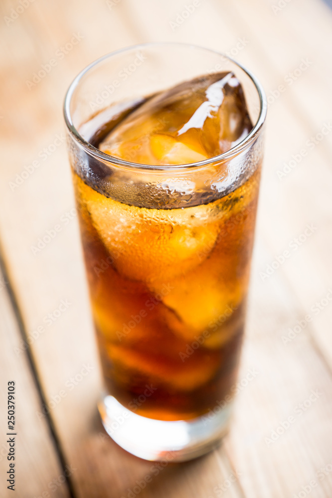 Cold cola beverage in glass with ice. Selective focus. Shallow depth of field. Cold cola beverage in glass with ice. Selective focus. Shallow depth of field.