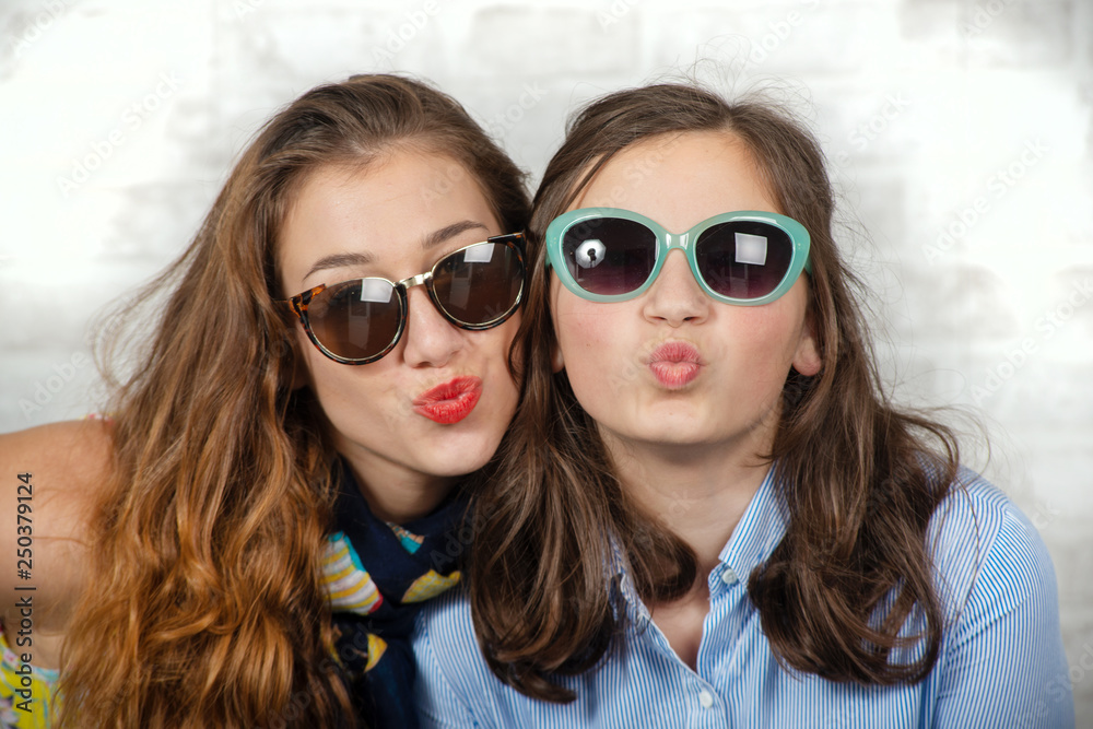 portrait of pretty beautiful charming adorable with long hair girl and her older friend portrait of pretty beautiful charming adorable with long hair girl and her older friend