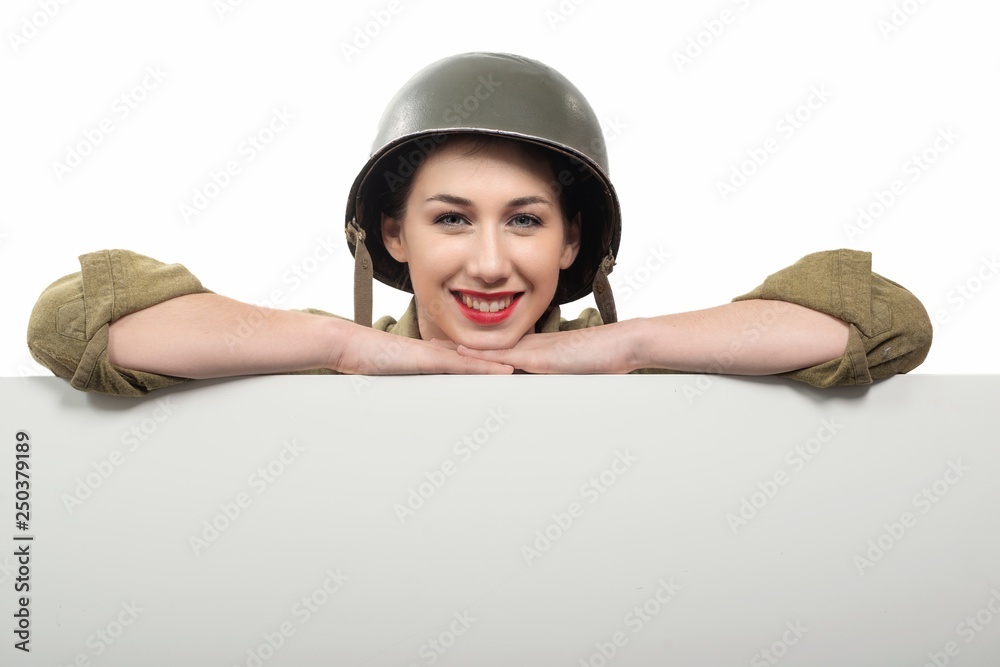 young woman dressed in wwii military uniform with helmet showing young woman dressed in wwii military uniform with helmet showing