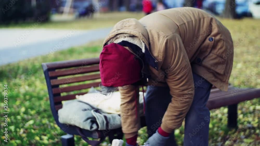 Homeless beggar man outdoors in park. Homeless beggar man outdoors in park.