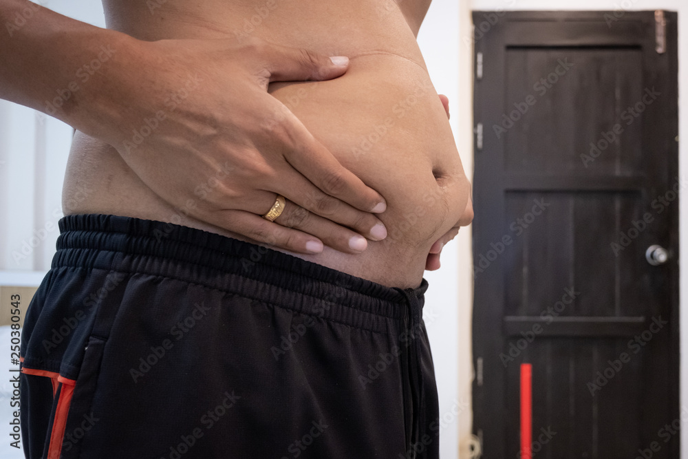 Naklejka premium Man touching his fat belly