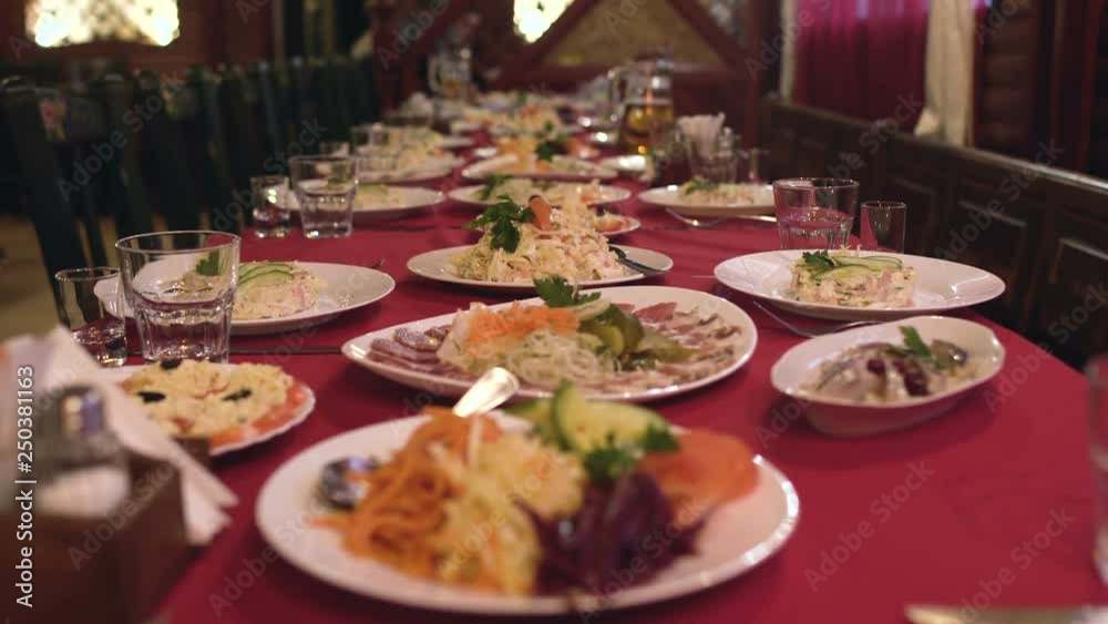 plates of food and salads are on the table in restaurant or cafe, banquet table for corporate dinner plates of food and salads are on the table in restaurant or cafe, banquet table for corporate dinner