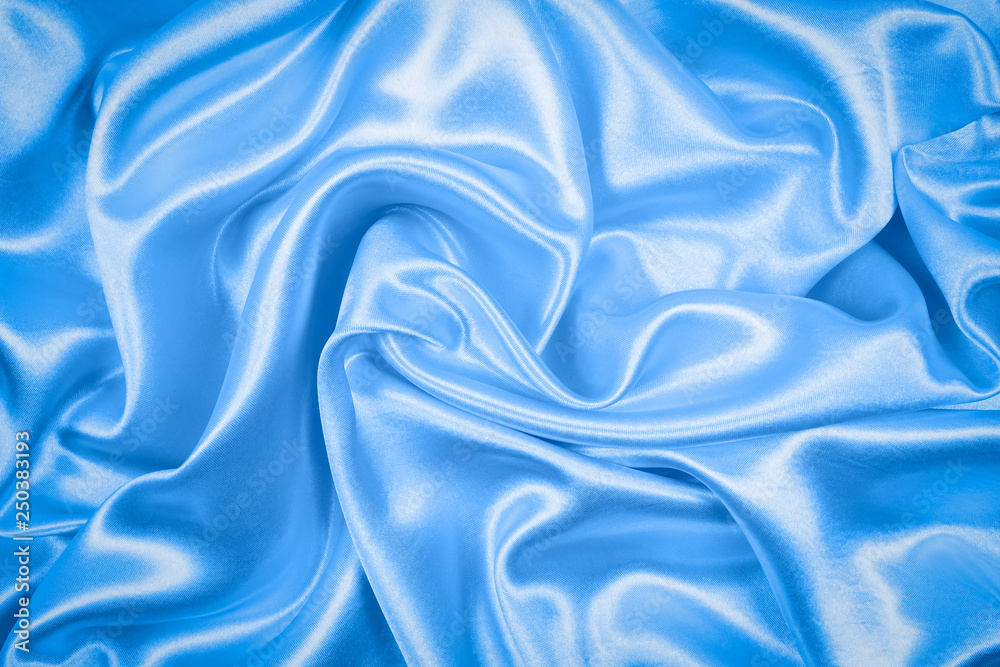Smooth elegant blue silk or satin texture can use as abstract background. fabric color
