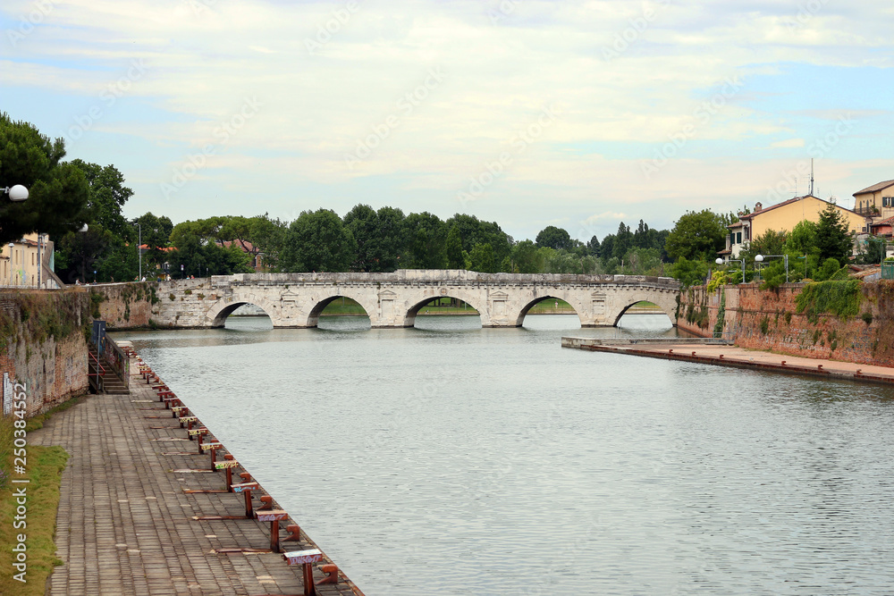 old stone Tiberius bridge Rimini cityscape Italy