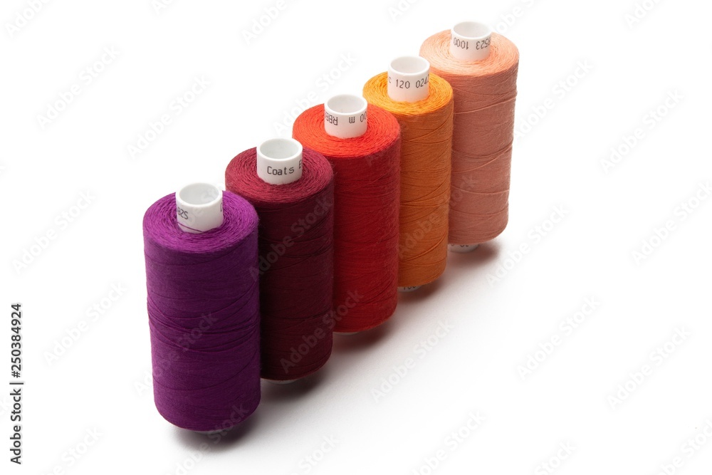 Set of color spool sewing threads on isolated white background Set of color spool sewing threads on isolated white background